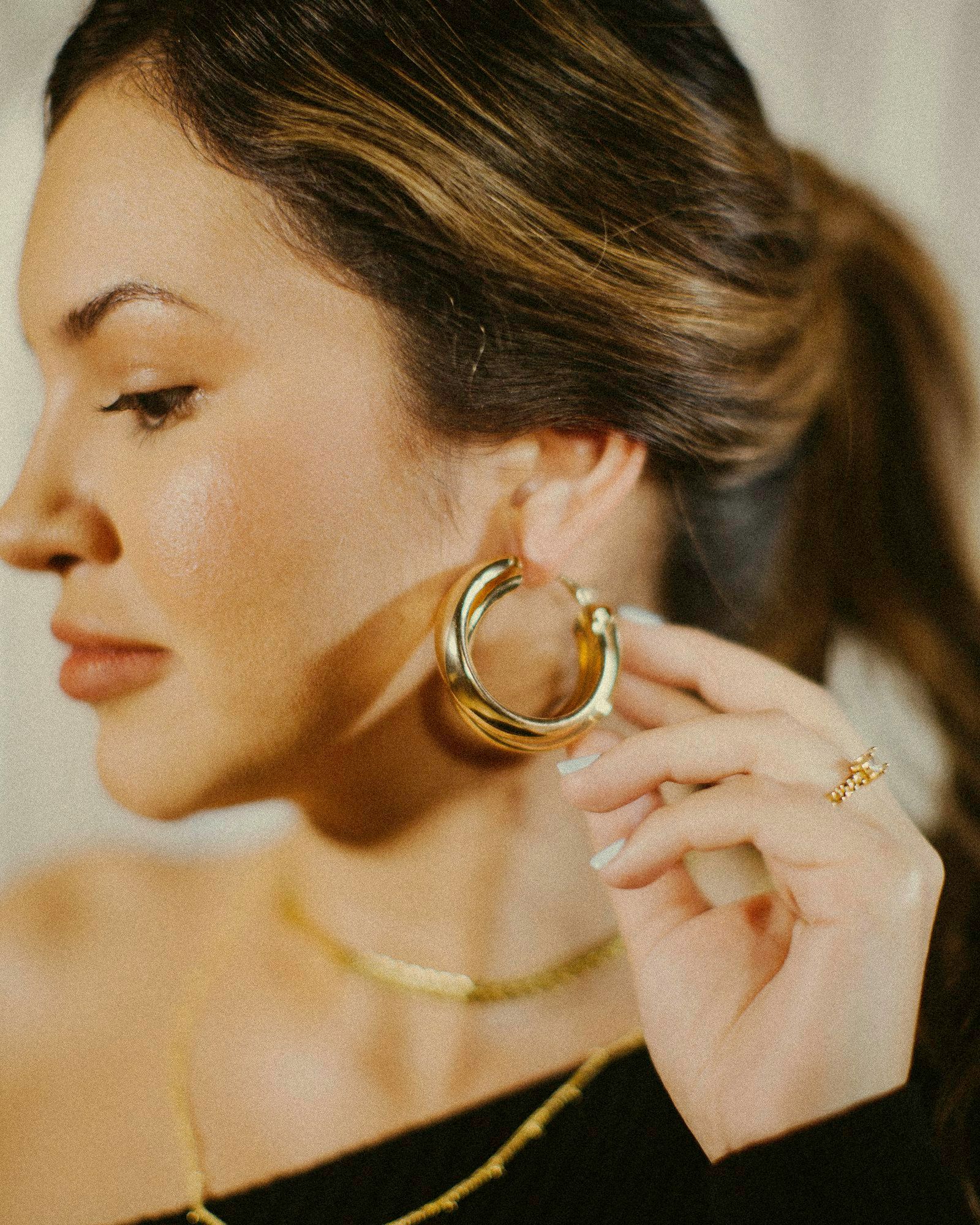 Woman wearing gold hoop earrings